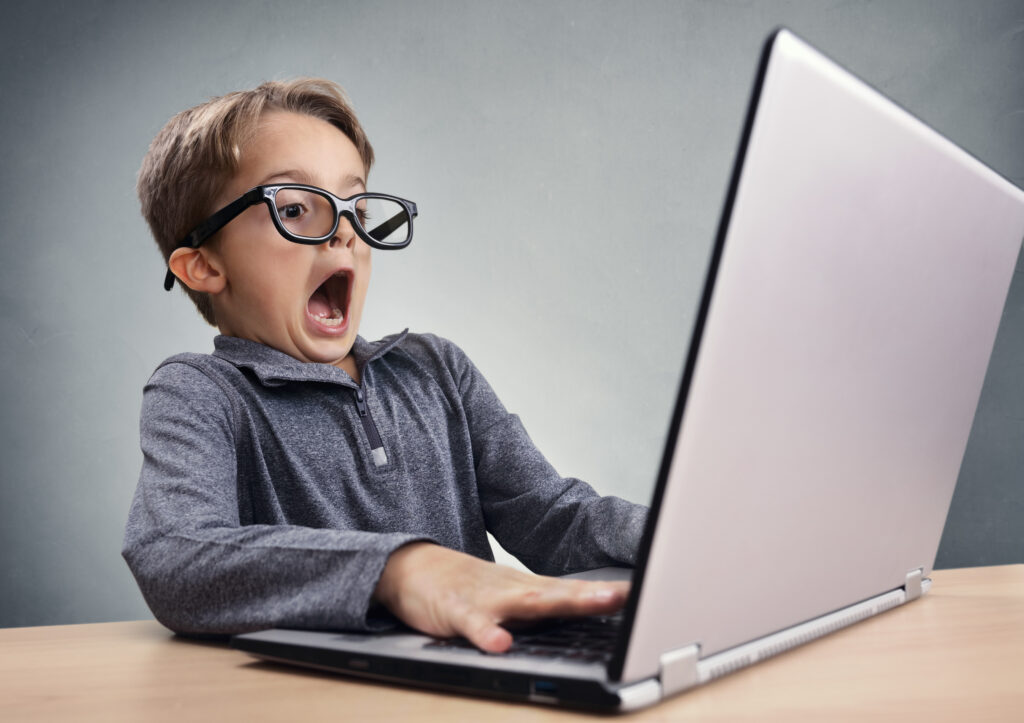 An image of a disgruntled person in front of a computer.