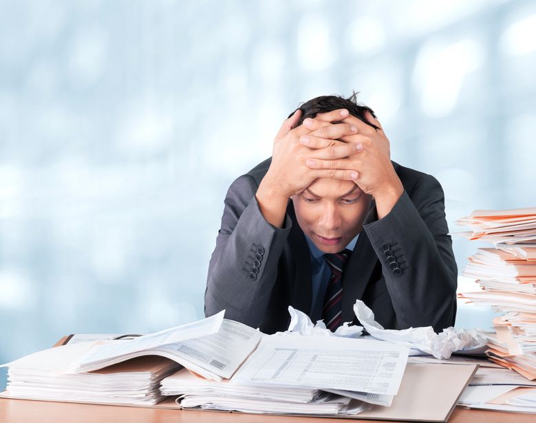 An image of an HOA board member looking through paperwork. 