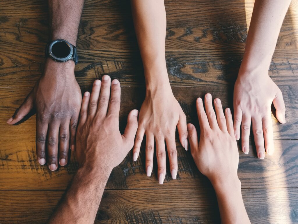 An image of people with their hands together in collaboration!